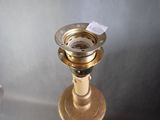 a gold candle that has a tag on it