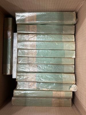 a lot of books in a box that are wrapped in plastic