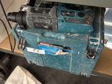 a blue machine that is sitting on a workbench