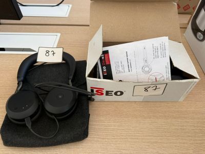 a box with a pair of headphones in it on a desk
