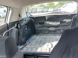 two seats in the back of a car with a tray in the back