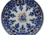 a blue and white plate with a design on it