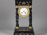 a black and gold clock sitting on top of a table