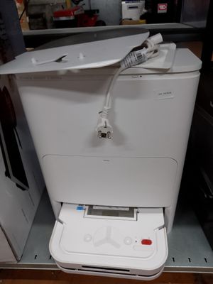 une imprimante blanche posée sur un meuble blanc