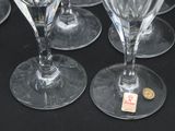 several empty wine glasses are lined up on a black table
