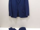 a blue suit and a pair of pants sitting on a bed