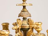 a gold colored chandelier with many candles on it