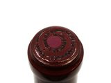 a close up of a bottle of wine on a white surface