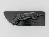 sculpture of a mouse on a black plate on a white surface