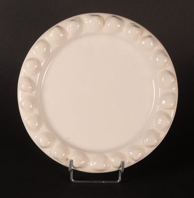 an image of a white plate sitting on top of a black table