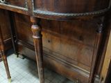 a wooden table with a marble top in a room