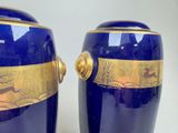 two blue vases with gold designs on them