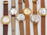 several different types of watches are displayed on a white surface
