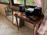 a small table with a printer on it in front of a window