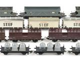 a lot of toy trains that are on a white surface