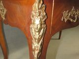 a wooden table with a gold decoration on it