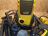 a yellow and black power washer and other tools on the floor