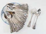 a plate with silver spoons and spoons on it