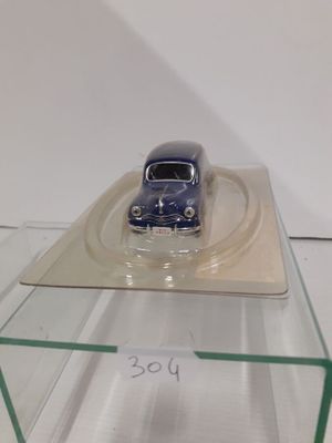 a small toy car on a clear display case