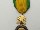 a close up of a medal on a white surface