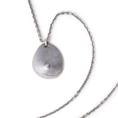 necklace with a silver stone on a silver chain on a white background