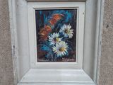 une photo d'un tableau représentant des fleurs, dans un cadre blanc