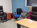 a room with several chairs and desks in it