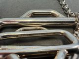 a close up of a metal buckle on a chain