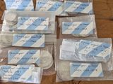 many different types of coins in bags on the table