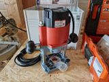 a red and black electric router sitting on a table