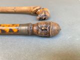 an old cane with a wooden handle sitting on top of a table