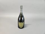 an empty bottle of wine sitting on top of a table