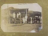 an old photo of a group of people standing in front of a building
