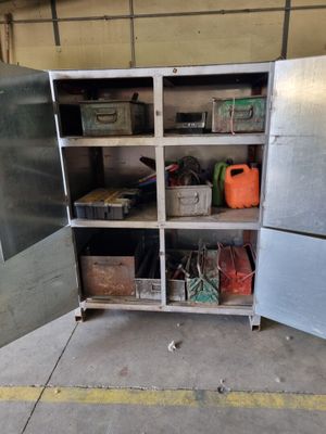 a metal cabinet with a bunch of items inside of it