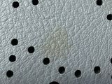 a close up of a piece of leather with holes in it