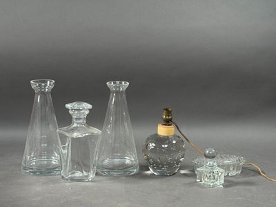a group of glass vases and a lamp on a table
