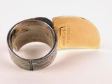 a silver ring with a gold piece in the middle