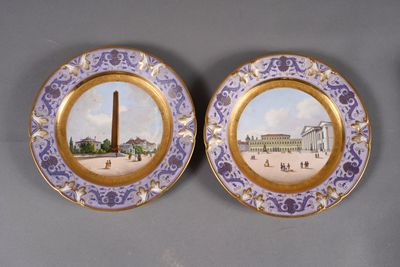 two plates with a picture of a monument and a building