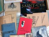 a lot of books on a table with a white table cloth