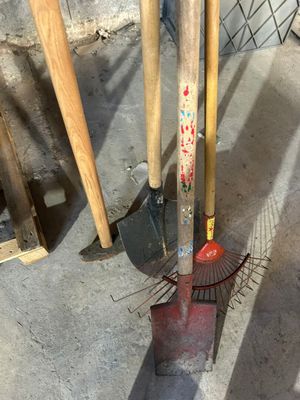 two shovels and a rake on the ground