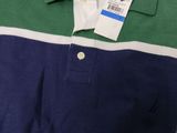a close up of a polo shirt with a tag on it