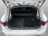 a trunk of a white car with the door open
