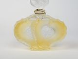 yellow and white glass perfume bottle with a heart on top