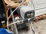 a machine that is sitting on the ground in front of a building