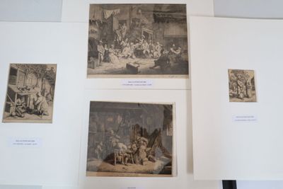 four pictures of people in a room with pictures on the wall