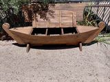 a wooden boat that is sitting on the ground