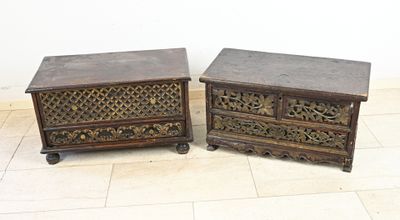 pair of antique carved wood chests on casteors on tiled floor