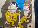 a poster of two men in yellow suits on a wall
