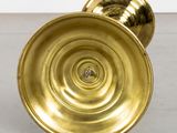 a gold plate that is sitting on the floor