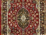 a red and black rug with a medallion design on it